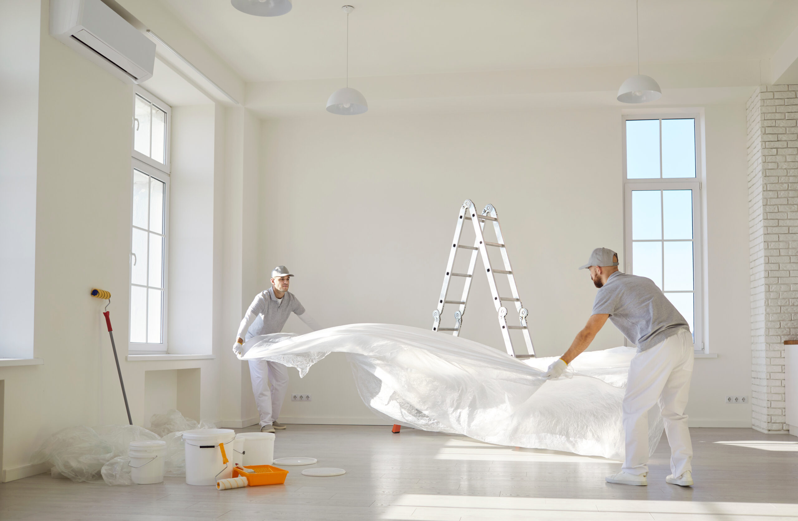 Painters team or construction workers planning repair, floor covering to protect during color renovation after moving into new apartment, interior design home plan, new house remodeling ideas