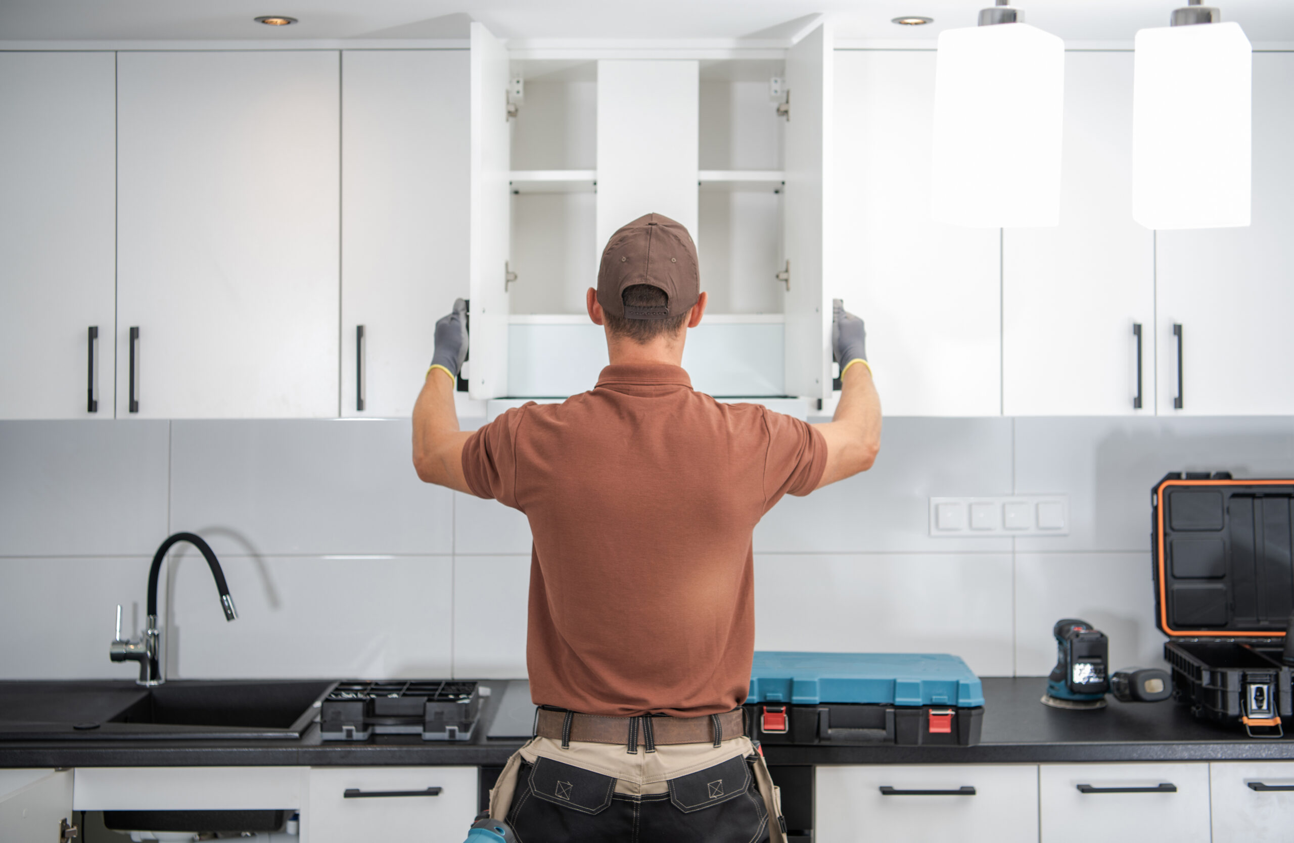 Modern White Kitchen Cabinets Installation Finished by Professional Cabinetmaker in His 40s. Furnishing Home Kitchen Theme.